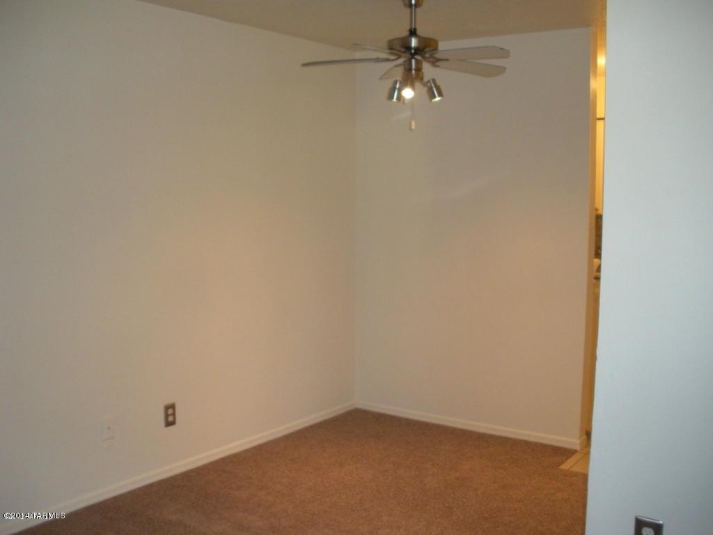 1600 North Wilmot Road, Unit 245 Tucson, AZ 85712 - Photo 7 of 12 an empty room with a fan & a window