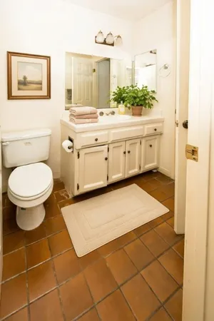 a bathroom with a sink a toilet and a mirror