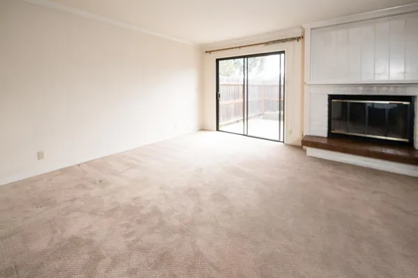 a view of empty room with a fireplace