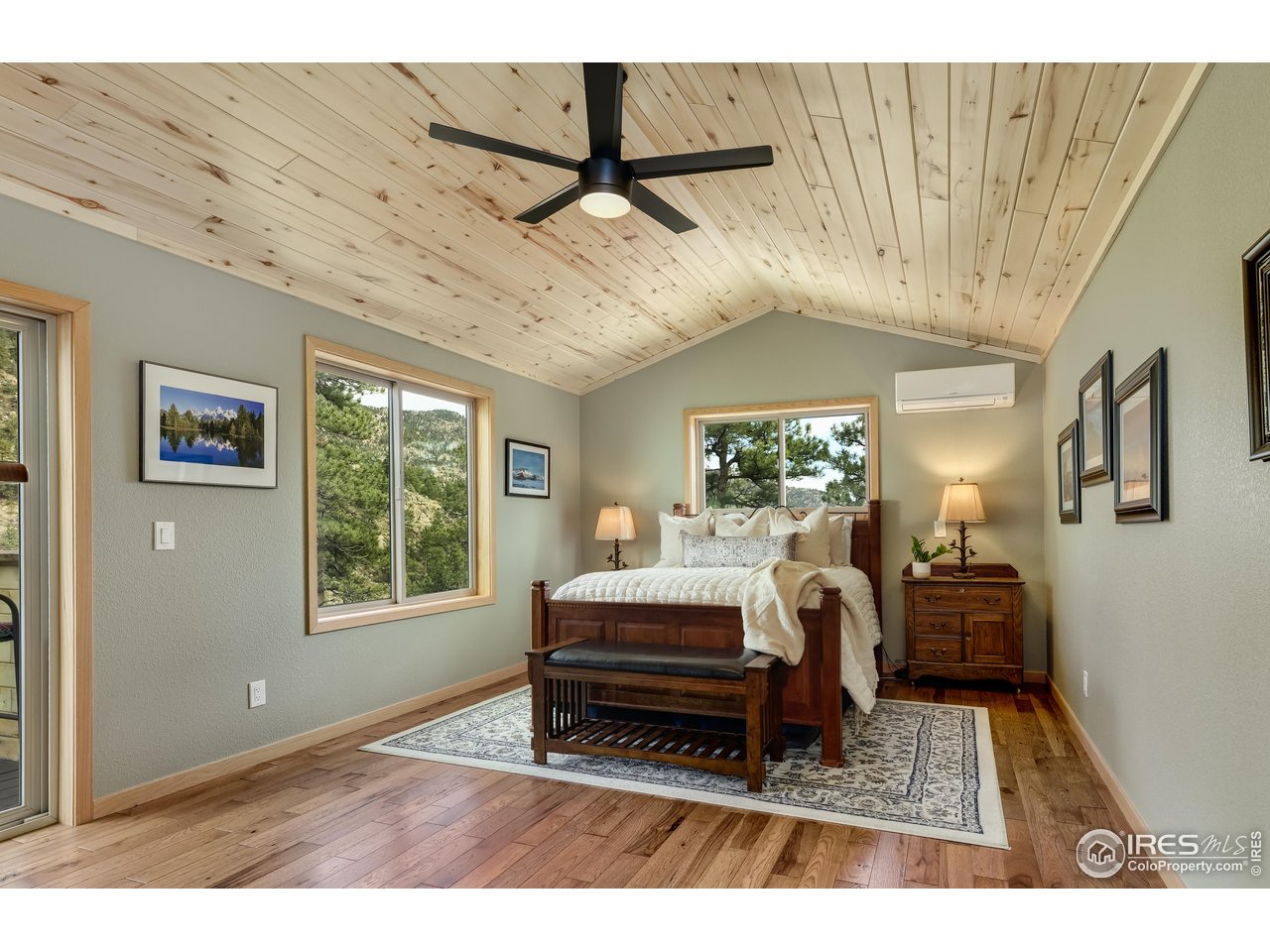 321 May Avenue Lyons, CO 80540 - Photo 19 of 50 a spacious bedroom with a bed and wooden floor