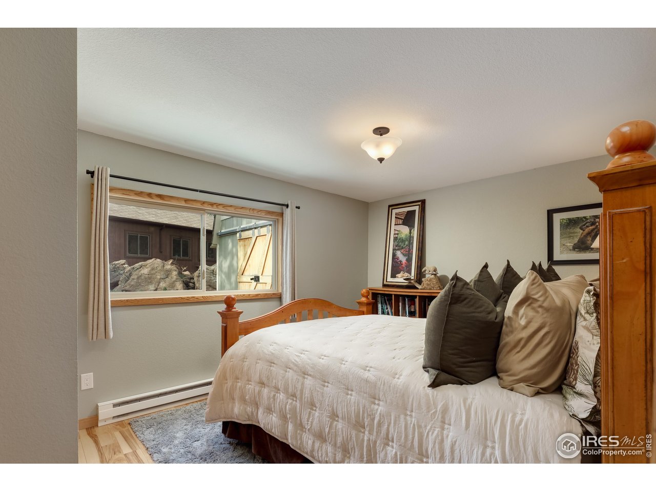 321 May Avenue Lyons, CO 80540 - Photo 26 of 50 a bedroom with a large bed and a window