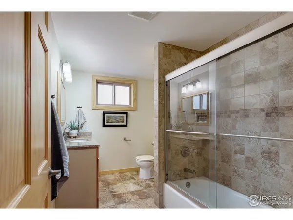 a bathroom with a sink and mirror with toilet