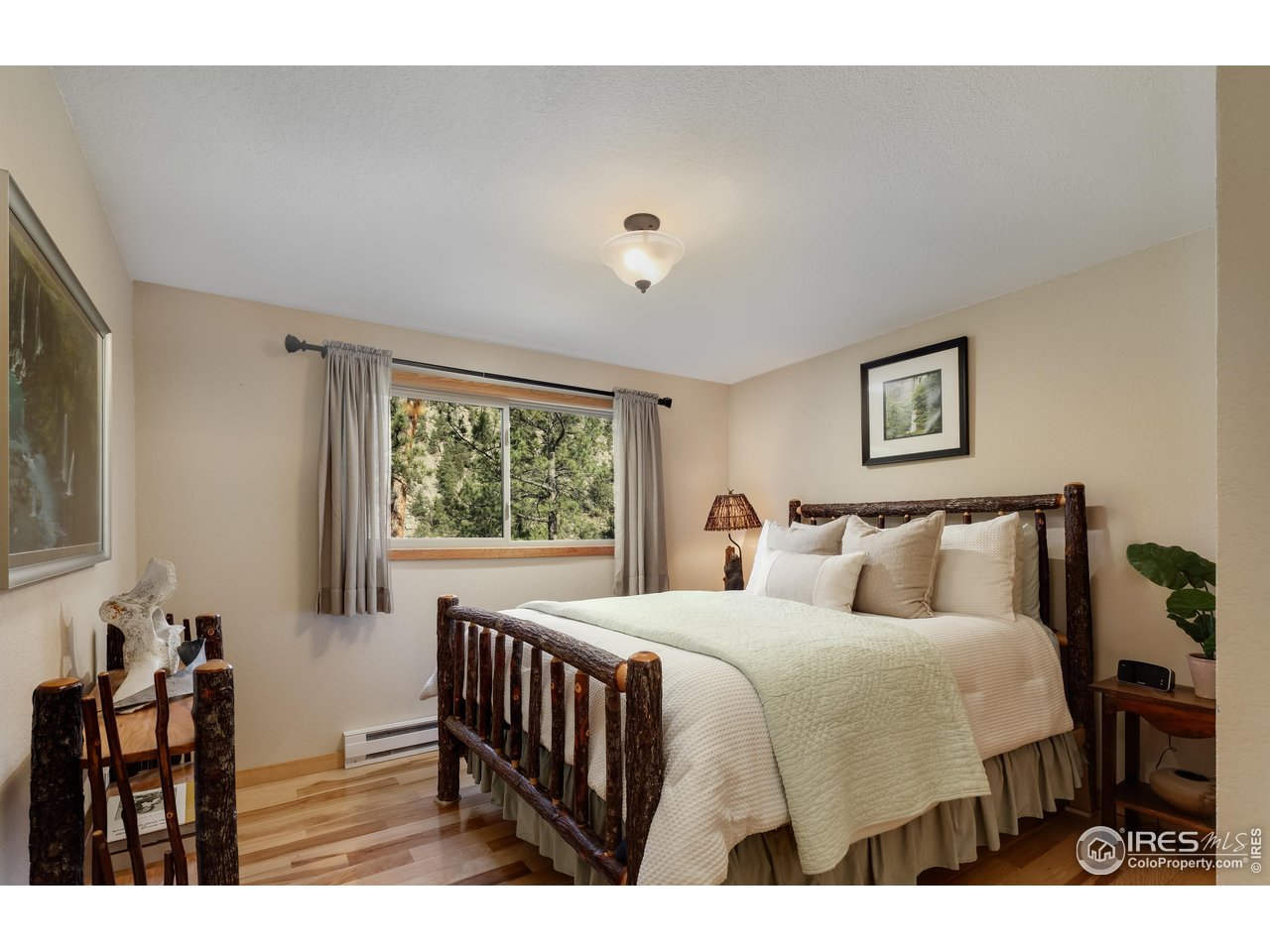 321 May Avenue Lyons, CO 80540 - Photo 27 of 50 a bedroom with a large bed and a window