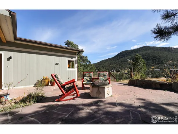 a backyard of a house with table and chairs