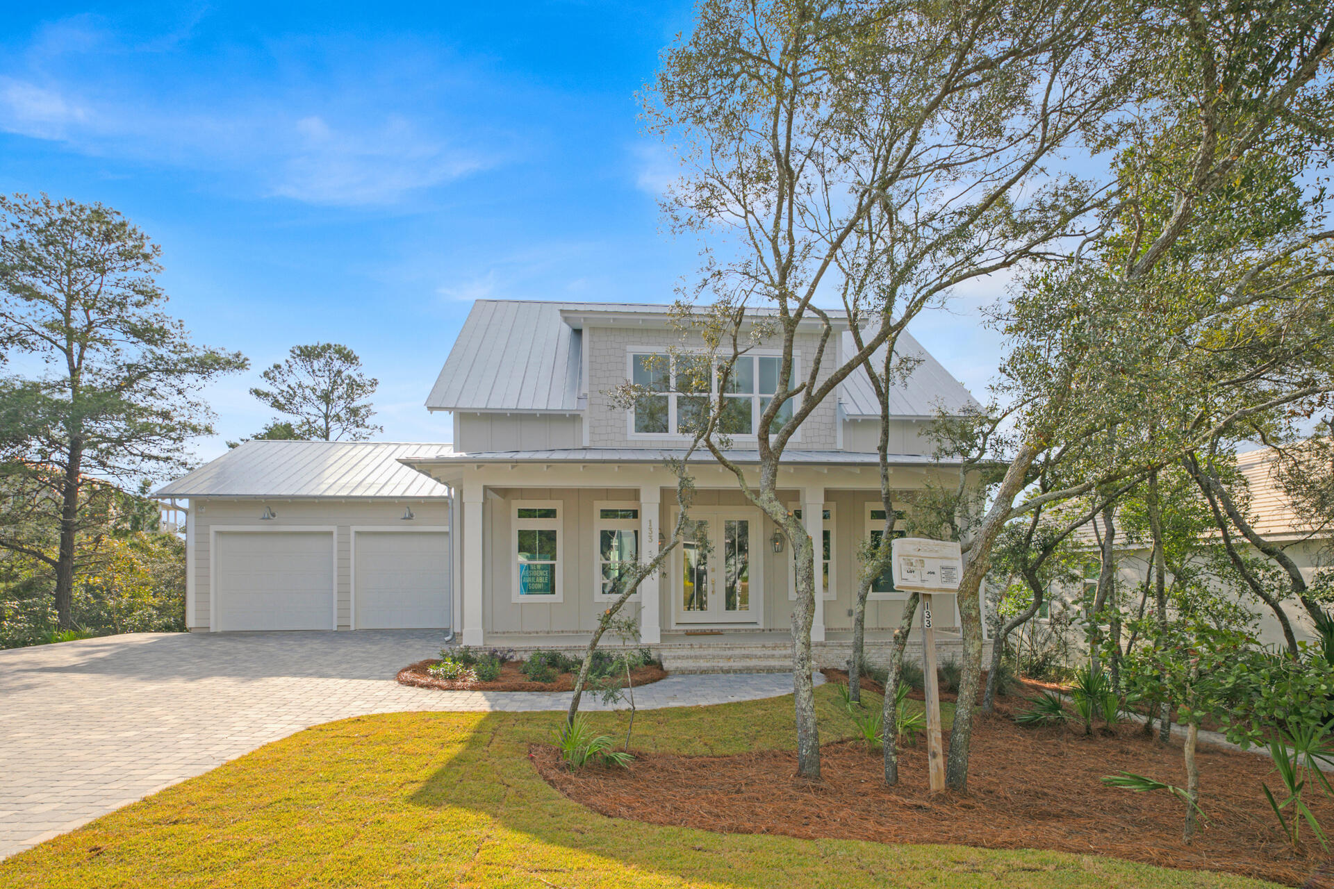 133 Dune Drive Santa Rosa Beach, FL 32459 - Photo 1 of 64 a front view of a house with a yard and garage