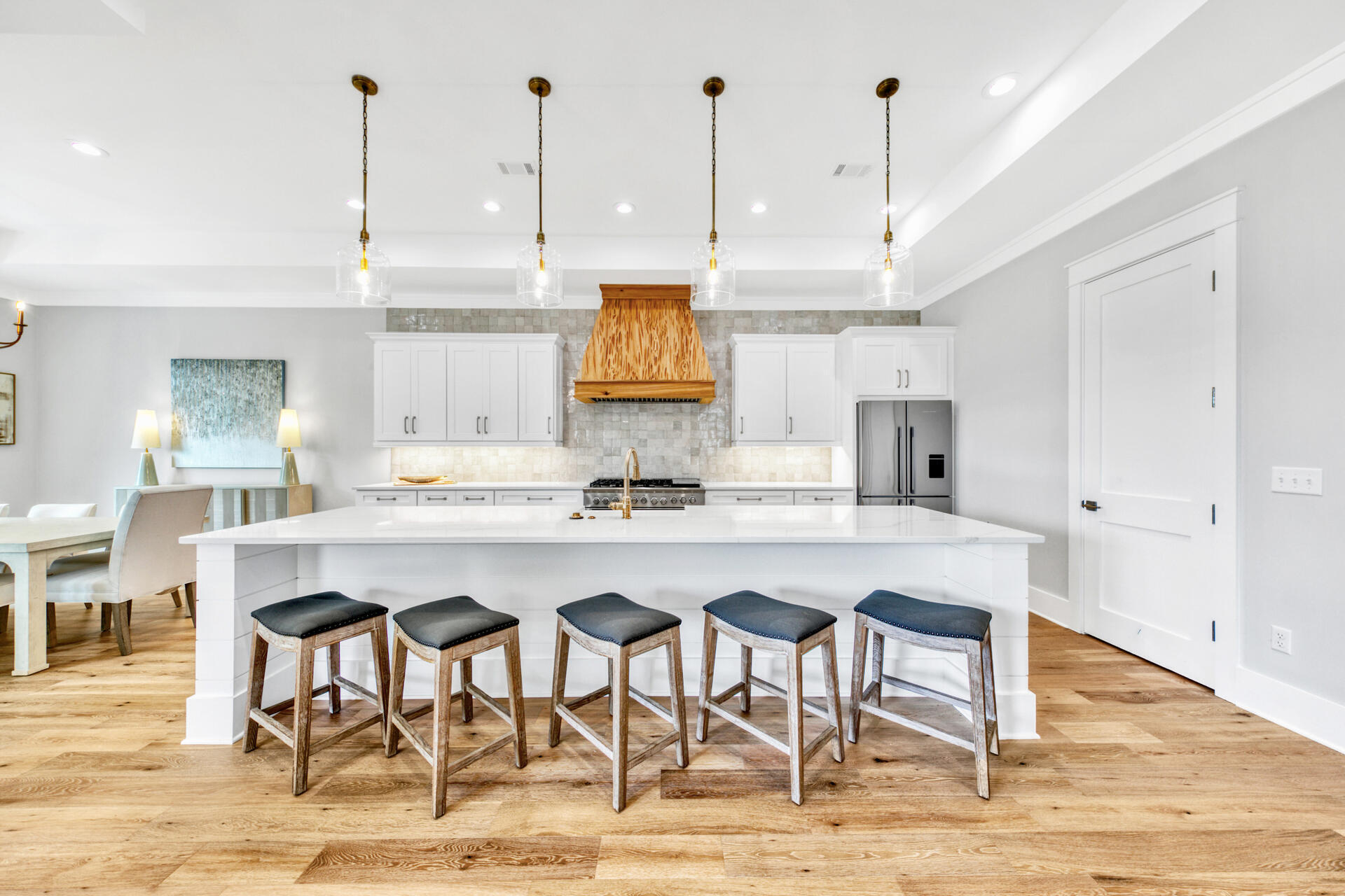133 Dune Drive Santa Rosa Beach, FL 32459 - Photo 11 of 64 a kitchen with stainless steel appliances kitchen island granite countertop a table chairs and white cabinets