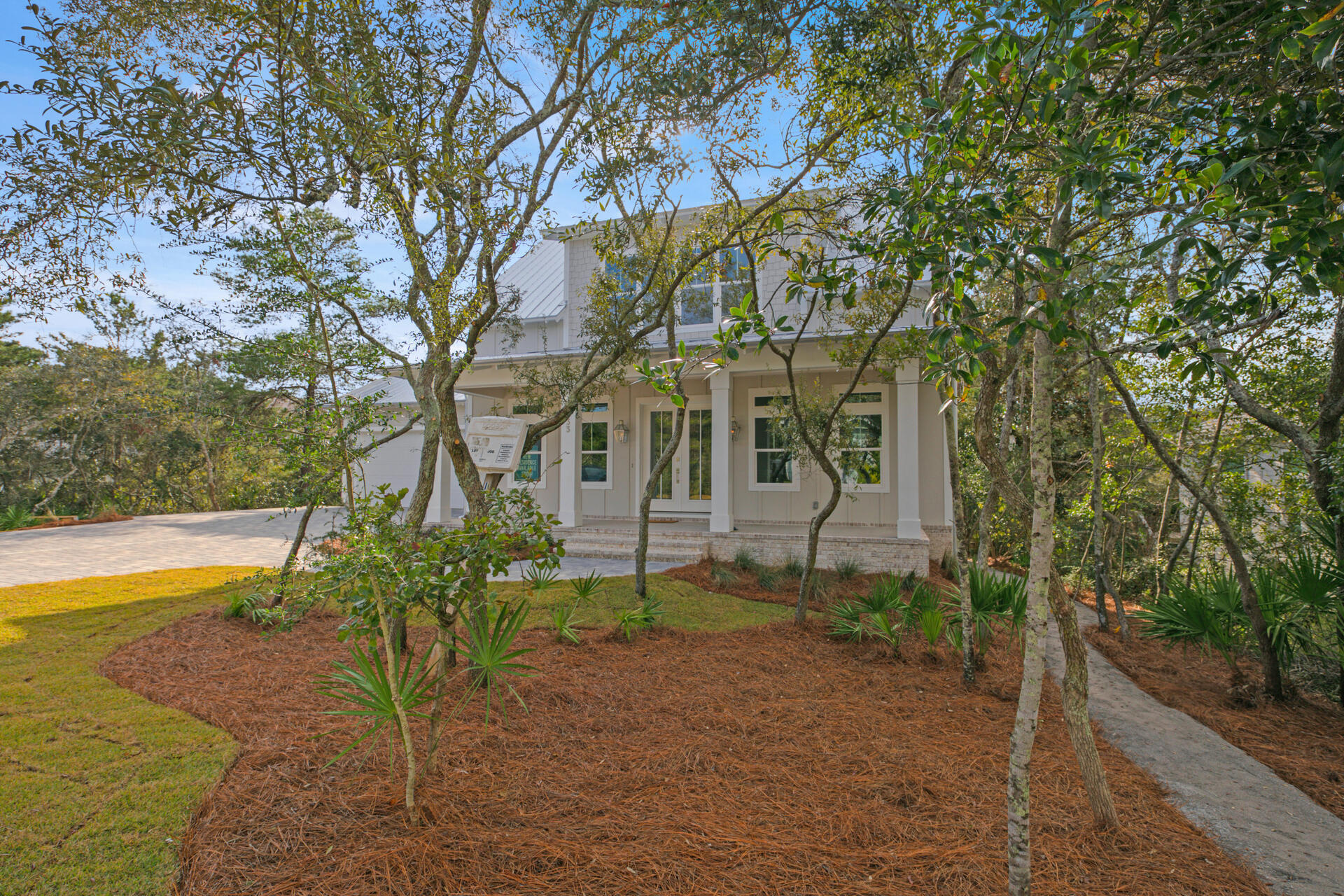 133 Dune Drive Santa Rosa Beach, FL 32459 - Photo 2 of 64 a view of a house with backyard and sitting area