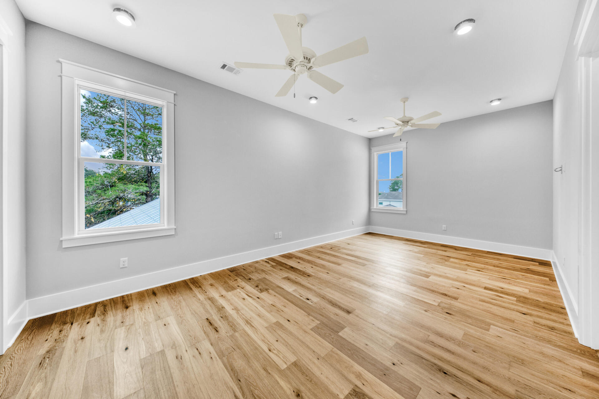 133 Dune Drive Santa Rosa Beach, FL 32459 - Photo 39 of 64 an empty room with wooden floor and windows