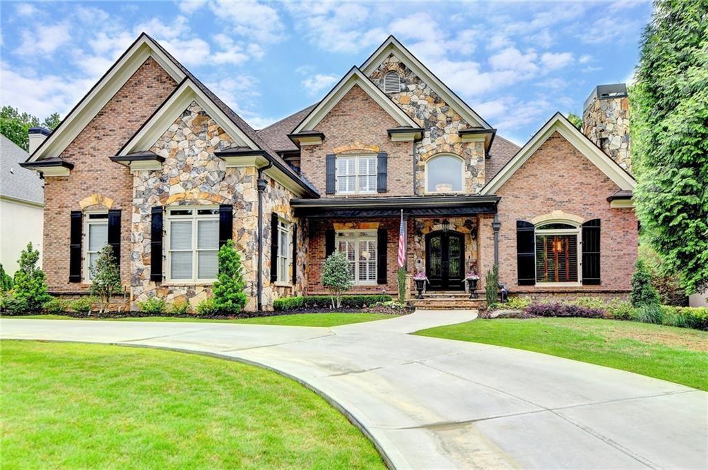 8760 Colonial Place Duluth, GA 30097 - Photo 2 of 5 front view of a brick house with a yard