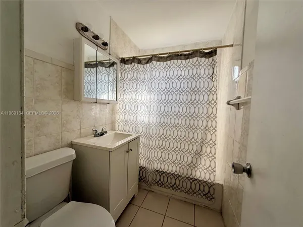 a bathroom with a toilet sink and shower