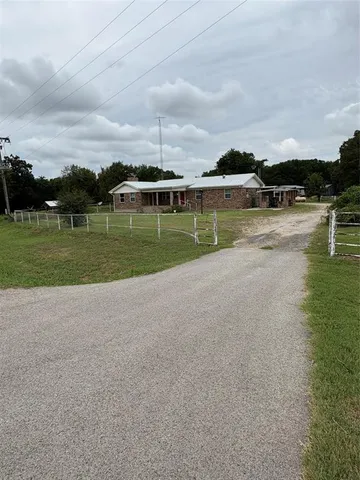 a view of a house with a yard and a lake view