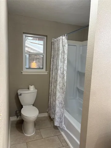 a bathroom with a toilet sink and shower