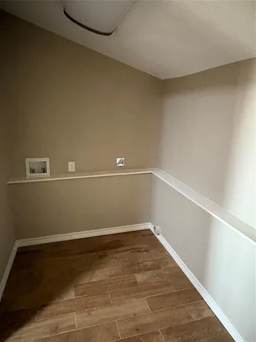 a view of a room with wooden floor