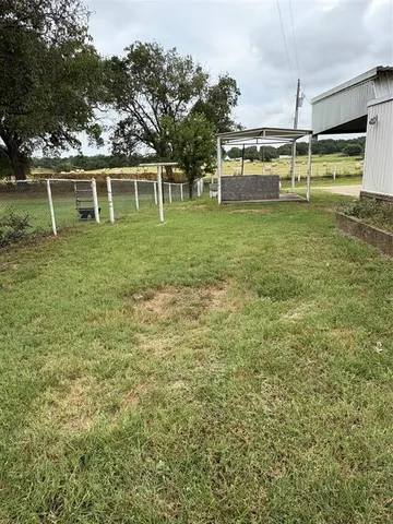 a swimming pool with trees in the background