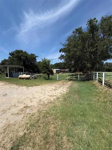 a view of a house with swimming pool and a yard