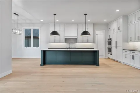 a view of kitchen with refrigerator and window
