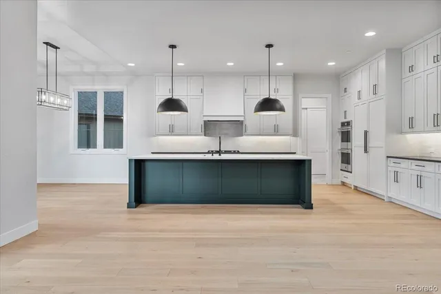 a view of kitchen with refrigerator and window