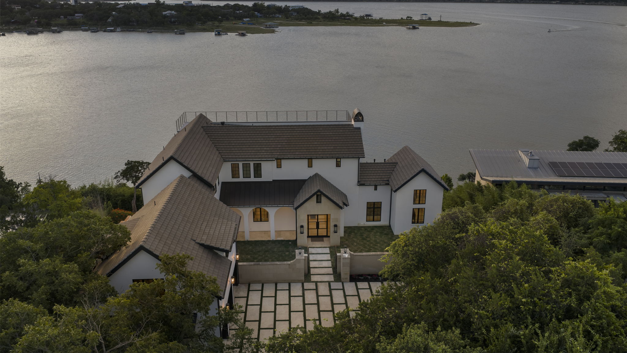 1496 Buffalo Gap Road Lakeway, TX 78734 - Photo 37 of 37 Perched above the serene lake, this expansive property offers a private oasis with a sophisticated design.