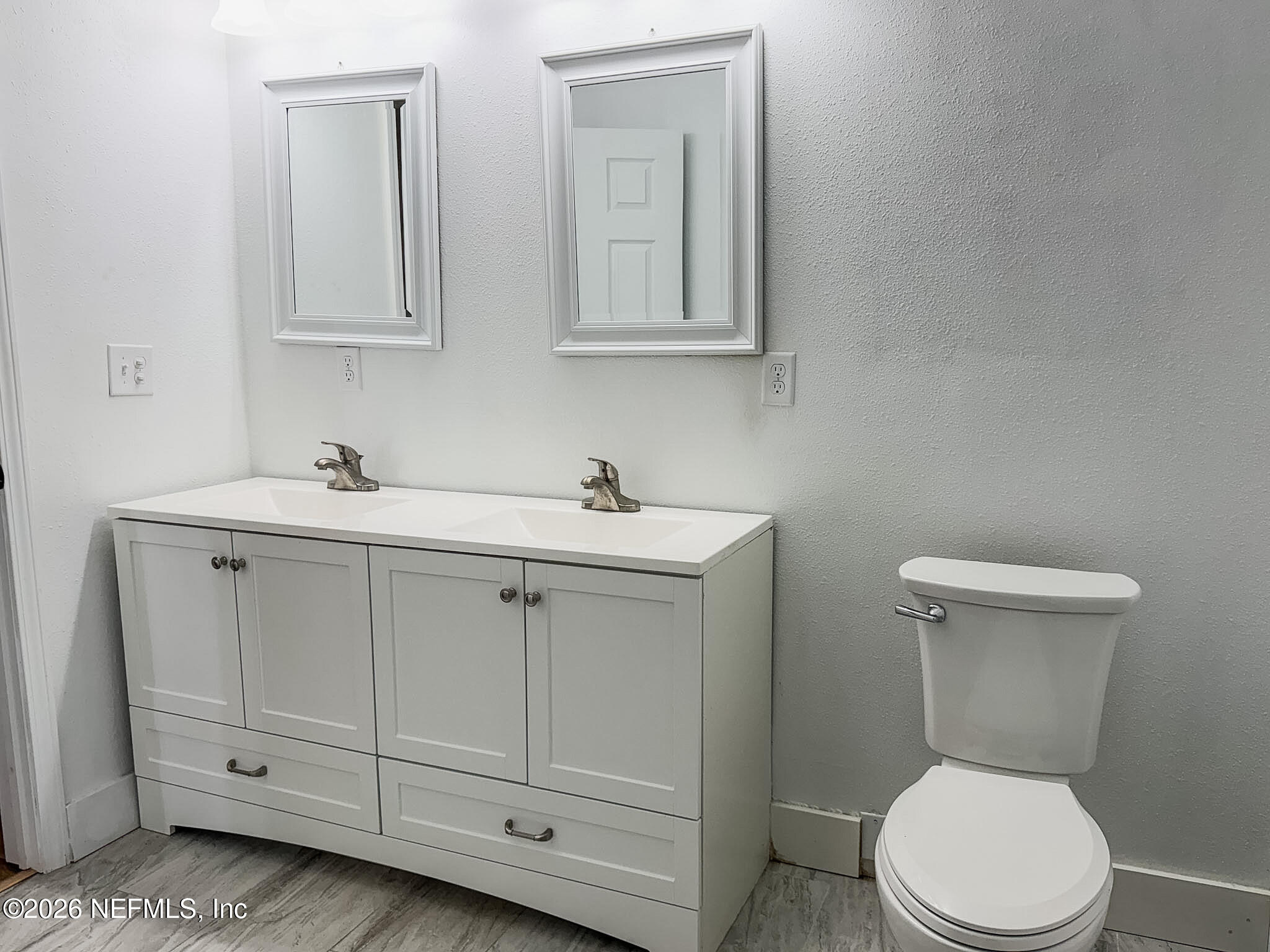 2589 Post Street Jacksonville, FL 32204 - Photo 12 of 19 a white toilet sitting next to a bathroom sink