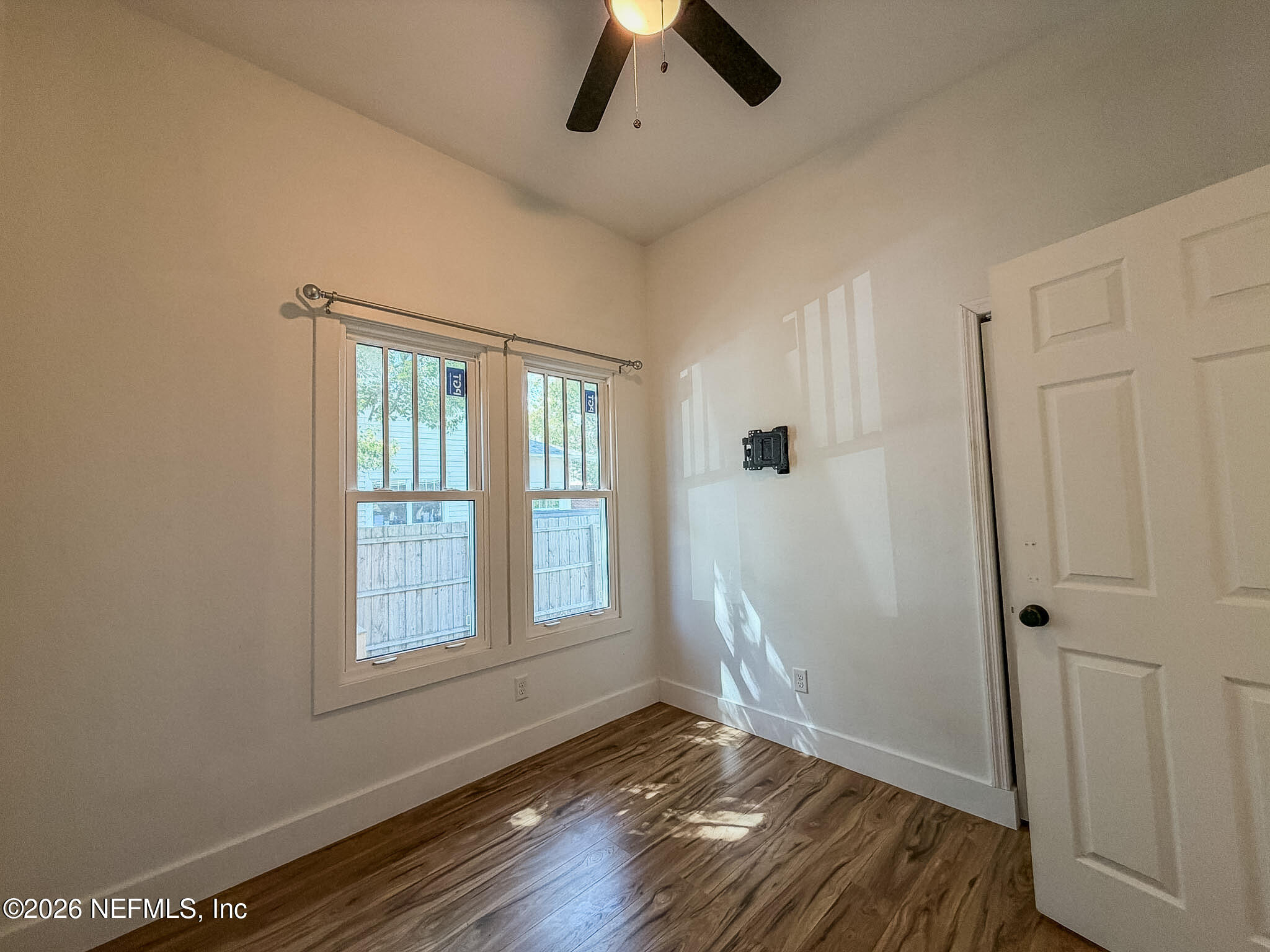 2589 Post Street Jacksonville, FL 32204 - Photo 14 of 19 a view of an empty room with wooden floor and a window