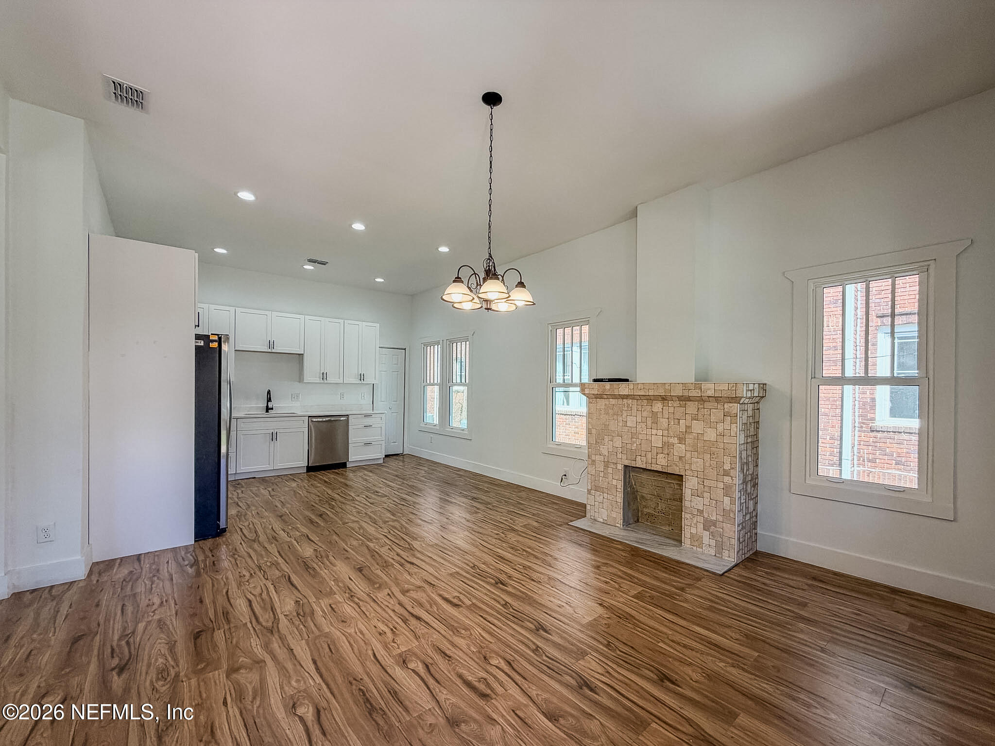 2589 Post Street Jacksonville, FL 32204 - Photo 5 of 19 a view of a kitchen with a ceiling fan wooden floor and a kitchen