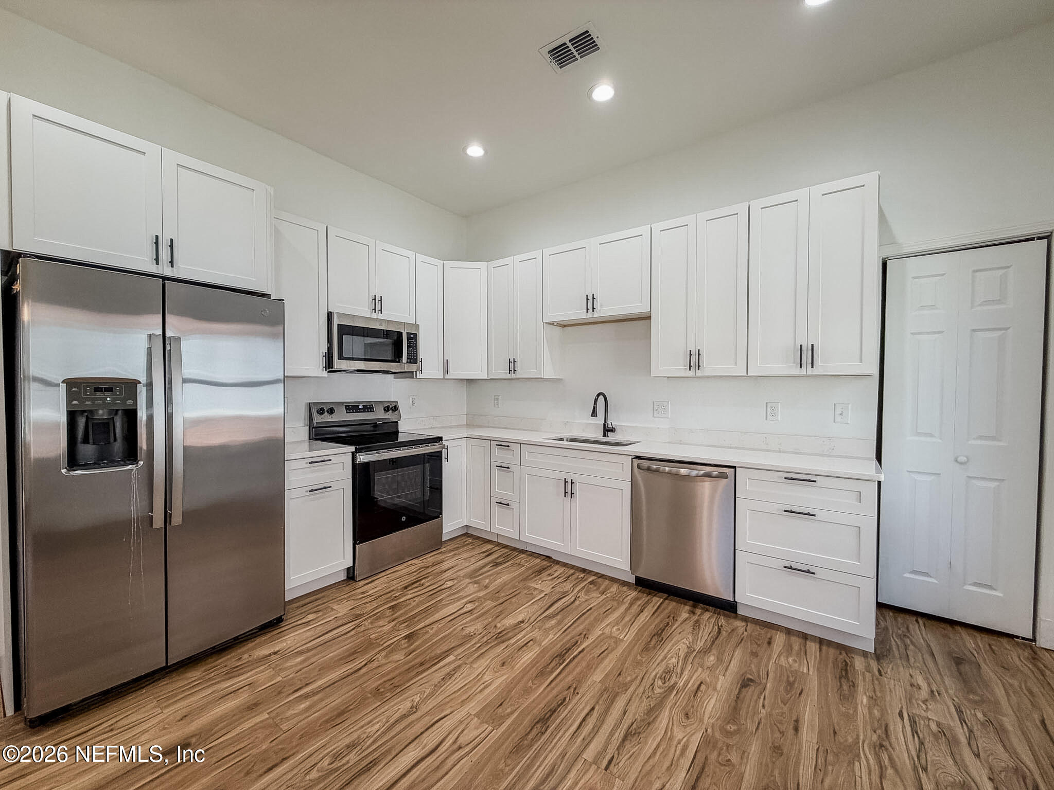 2589 Post Street Jacksonville, FL 32204 - Photo 6 of 19 a kitchen with granite countertop white cabinets and stainless steel appliances