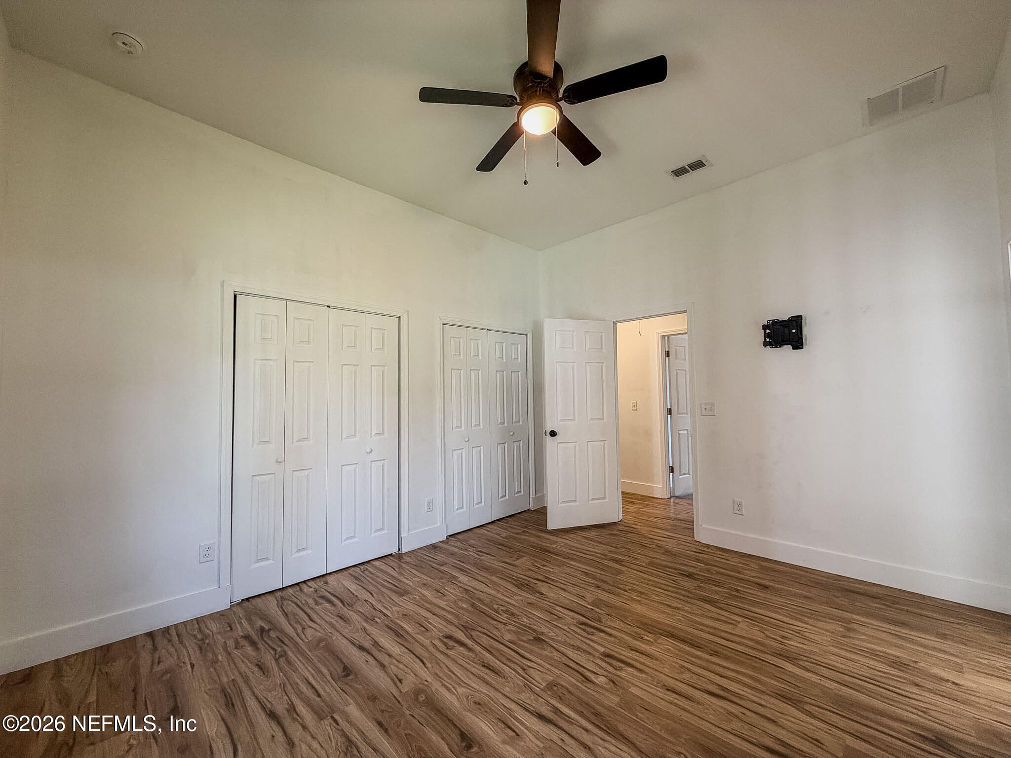 2589 Post Street Jacksonville, FL 32204 - Photo 9 of 19 an empty room with wooden floor fan and windows