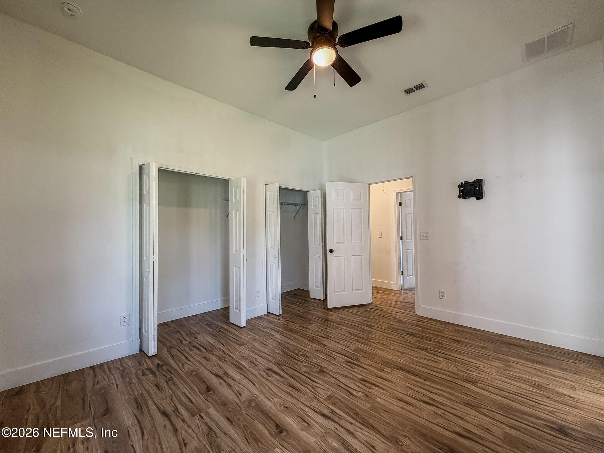 2589 Post Street Jacksonville, FL 32204 - Photo 10 of 19 an empty room with wooden floor and ceiling fan