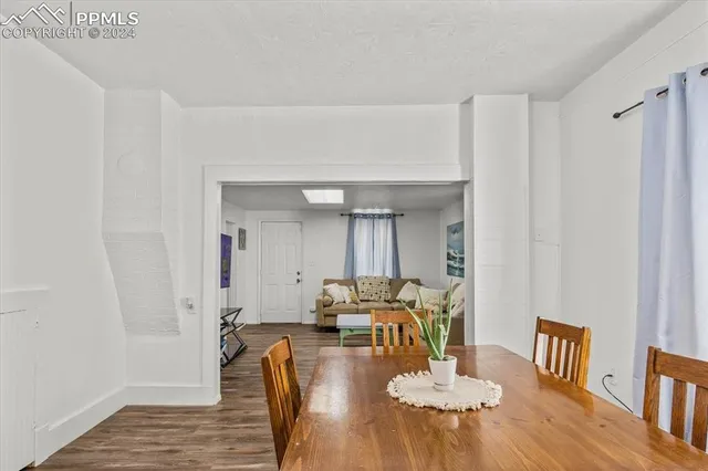 a dining room with furniture and wooden floor