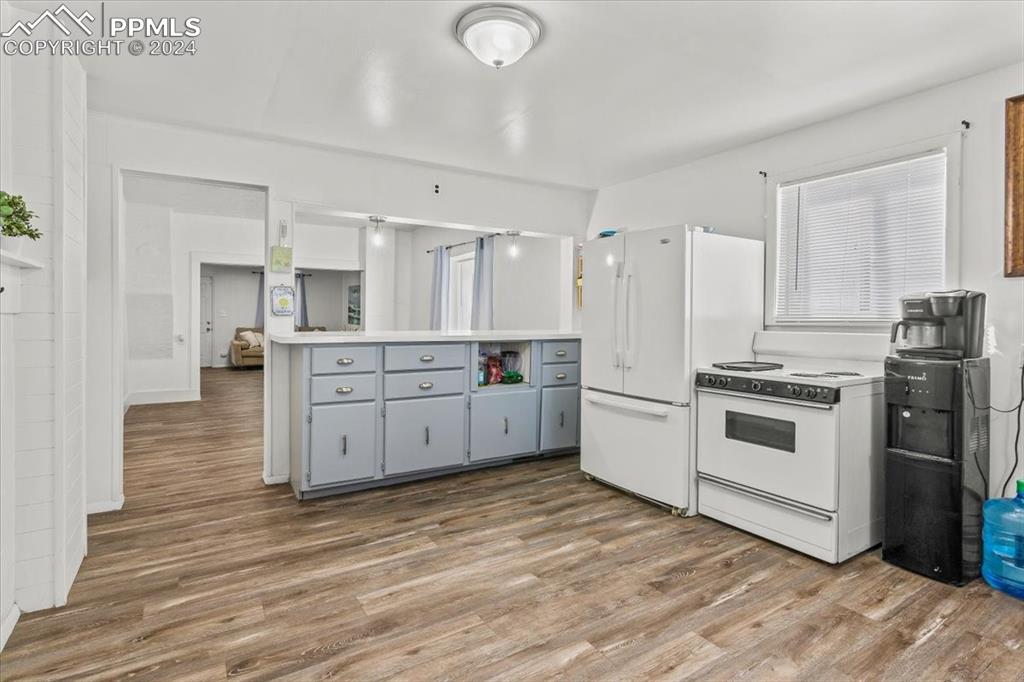 416 Wiley Avenue Swink, CO 81077 - Photo 16 of 43 a kitchen with stainless steel appliances white cabinets and wooden floors