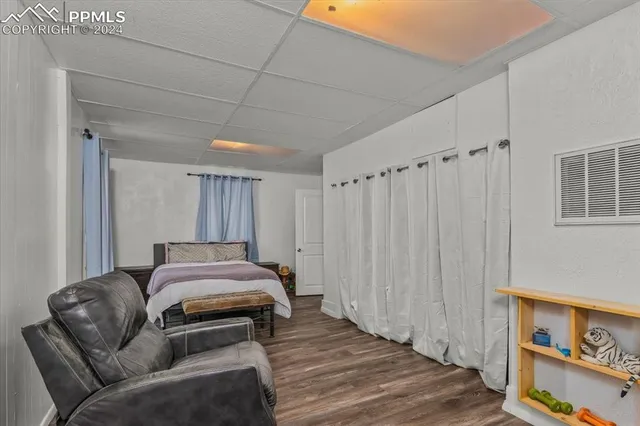 a bedroom with furniture and a wooden floor