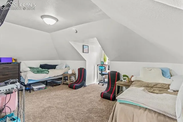 a bedroom with furniture and a wooden floor