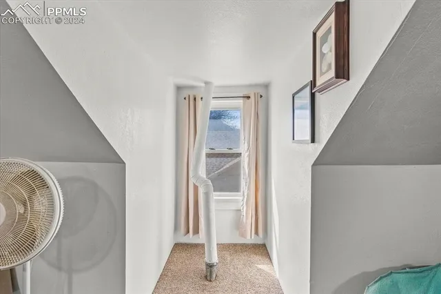 a view of a livingroom with wooden floor and entryway