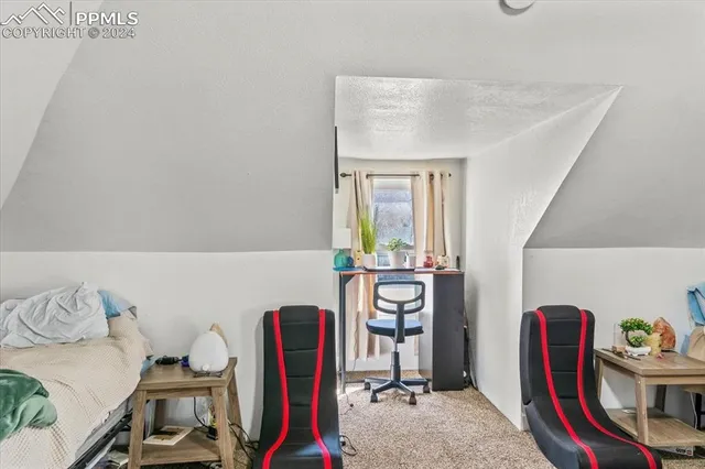 a living room with furniture a rug and a window