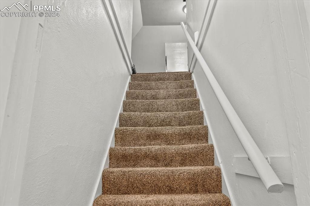 416 Wiley Avenue Swink, CO 81077 - Photo 31 of 43 a view of staircase with white walls and white door