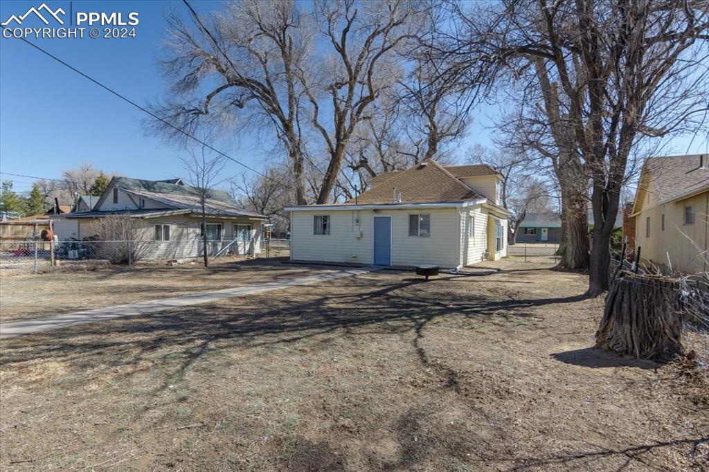 416 Wiley Avenue Swink, CO 81077 - Photo 36 of 43 a view of a white house next to a road with large trees