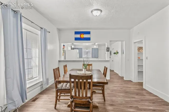 a view of a dining room with furniture and wooden floor