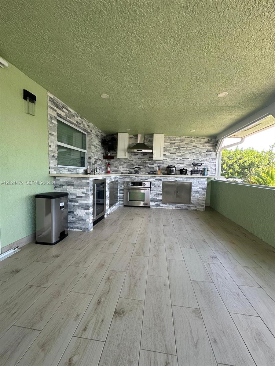 2212 Club House Road North Fort Myers, FL 33917 - Photo 25 of 40 a view of kitchen and hall with wooden floor