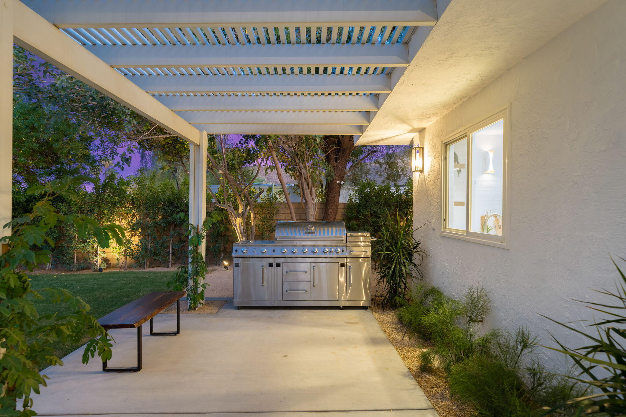 71540 Halgar Road Rancho Mirage, CA 92270 - Photo 13 of 51 a front view of a house with a garden