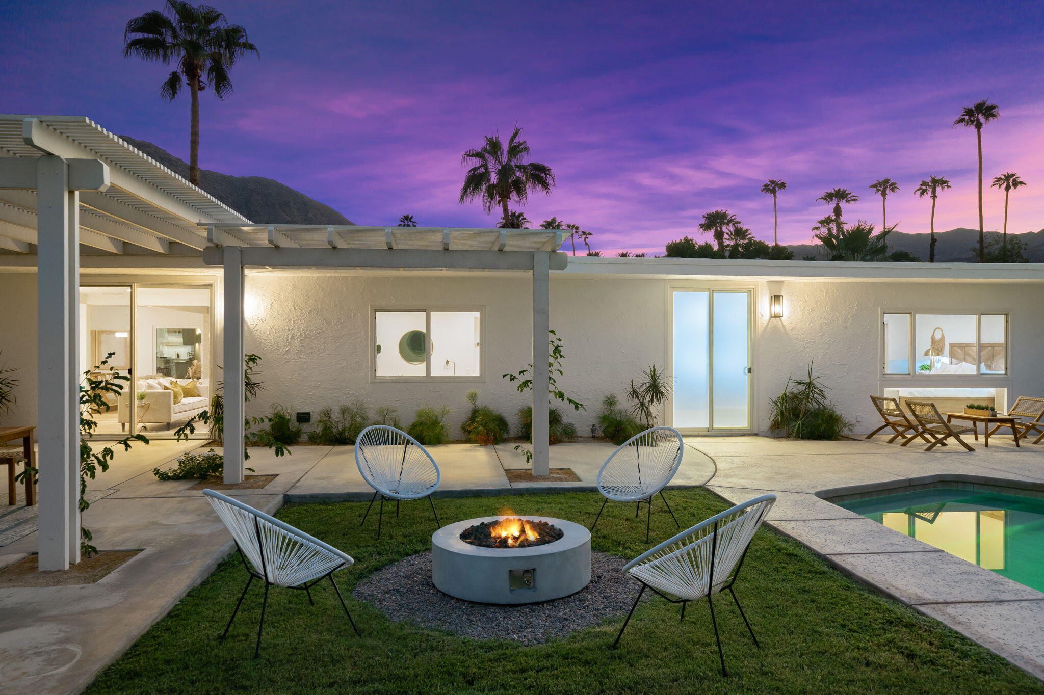 71540 Halgar Road Rancho Mirage, CA 92270 - Photo 18 of 51 a view of a patio with couches table and chairs with potted plants