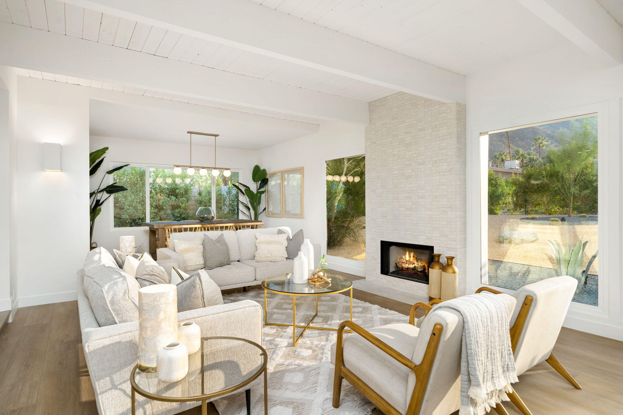 71540 Halgar Road Rancho Mirage, CA 92270 - Photo 22 of 51 a living room with furniture a fireplace and a large window