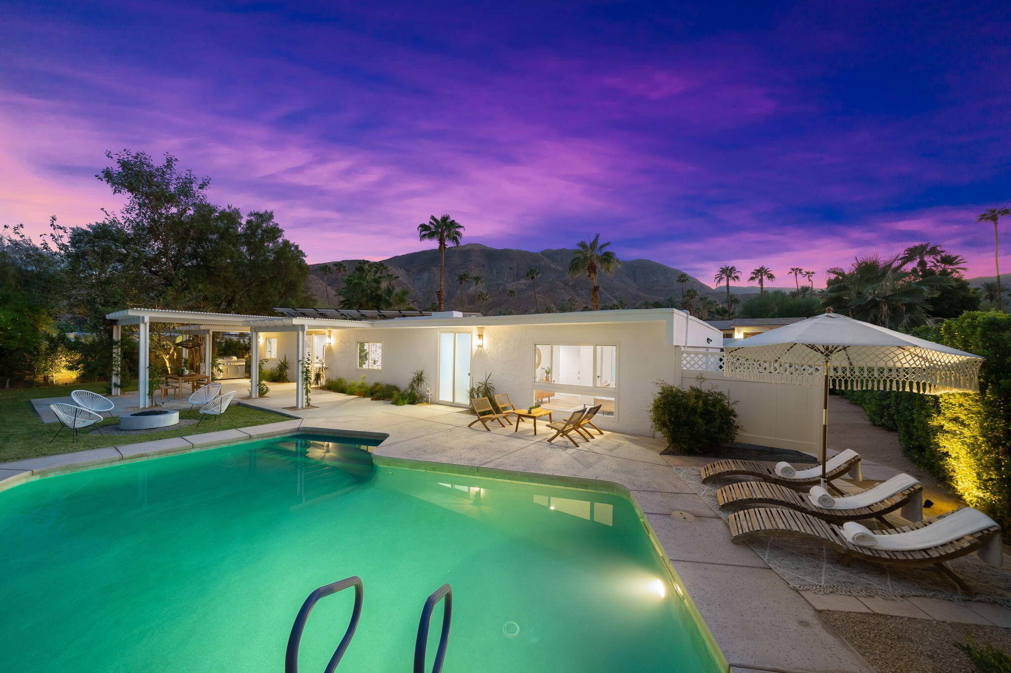 71540 Halgar Road Rancho Mirage, CA 92270 - Photo 3 of 51 a view of a swimming pool with lounge chairs in front of house