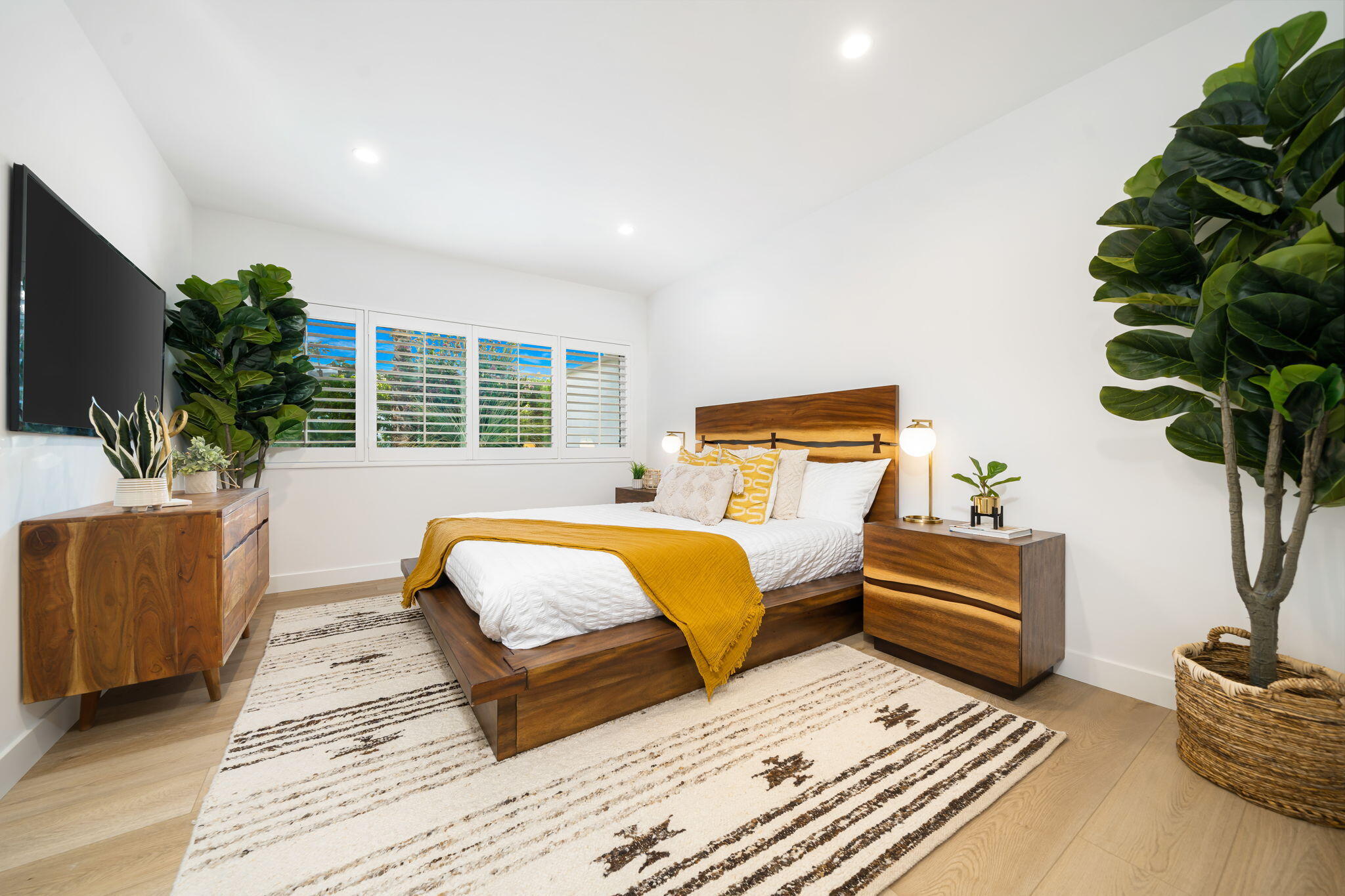 71540 Halgar Road Rancho Mirage, CA 92270 - Photo 36 of 51 a bedroom with a large bed and a potted plant