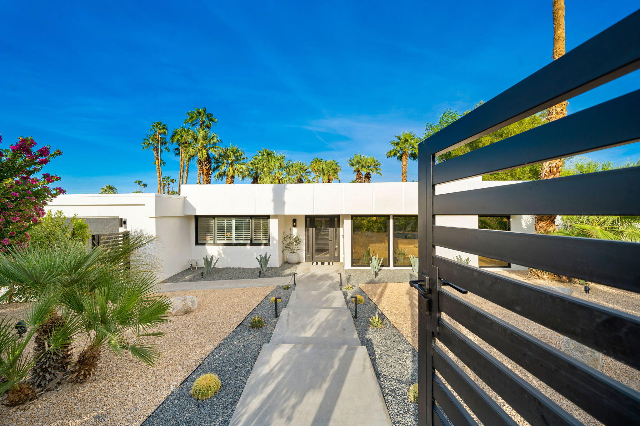 71540 Halgar Road Rancho Mirage, CA 92270 - Photo 43 of 51 a view of a patio with table and chairs and potted plants