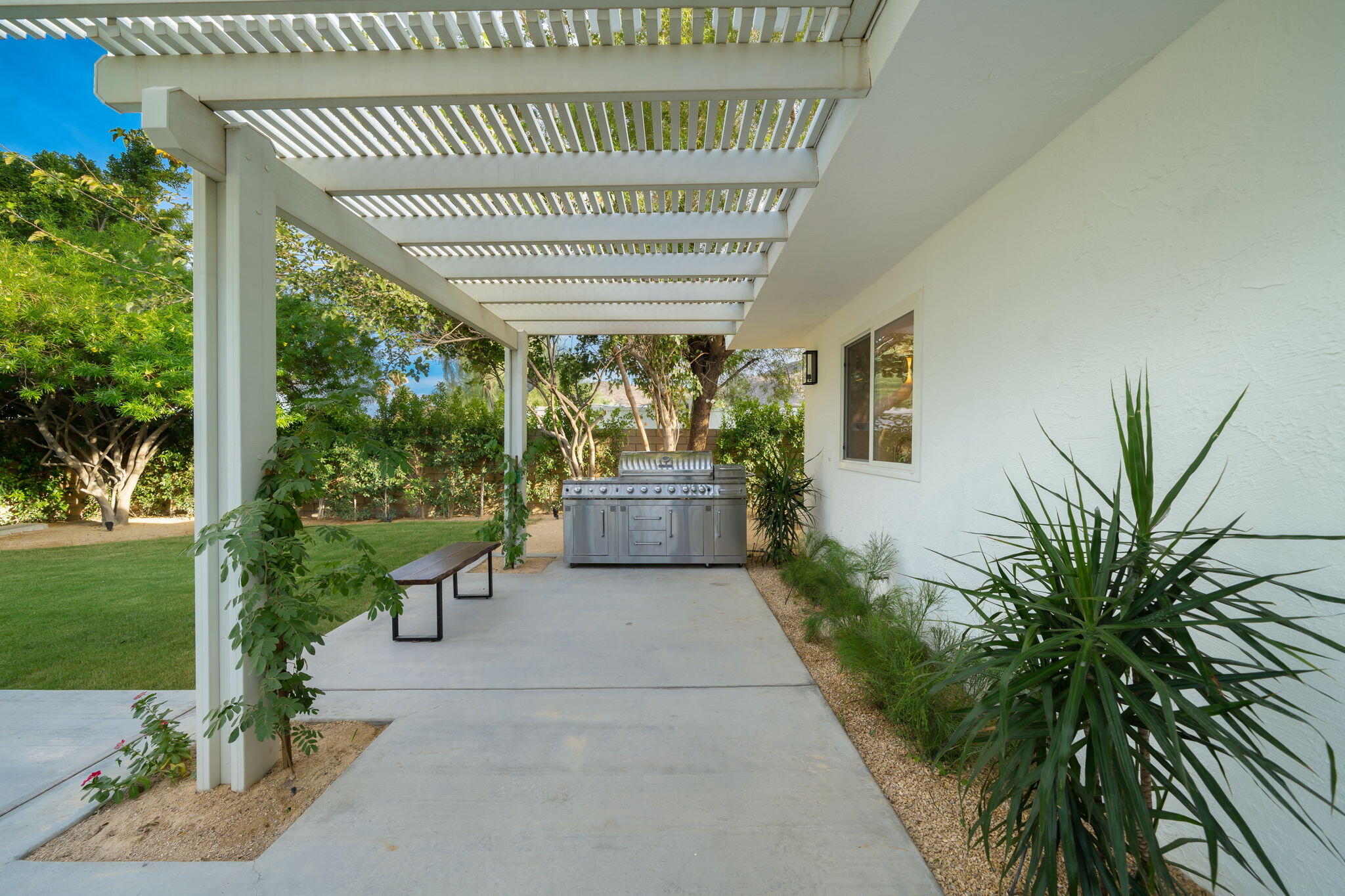 71540 Halgar Road Rancho Mirage, CA 92270 - Photo 46 of 51 a view of a patio with table and chairs and potted plants