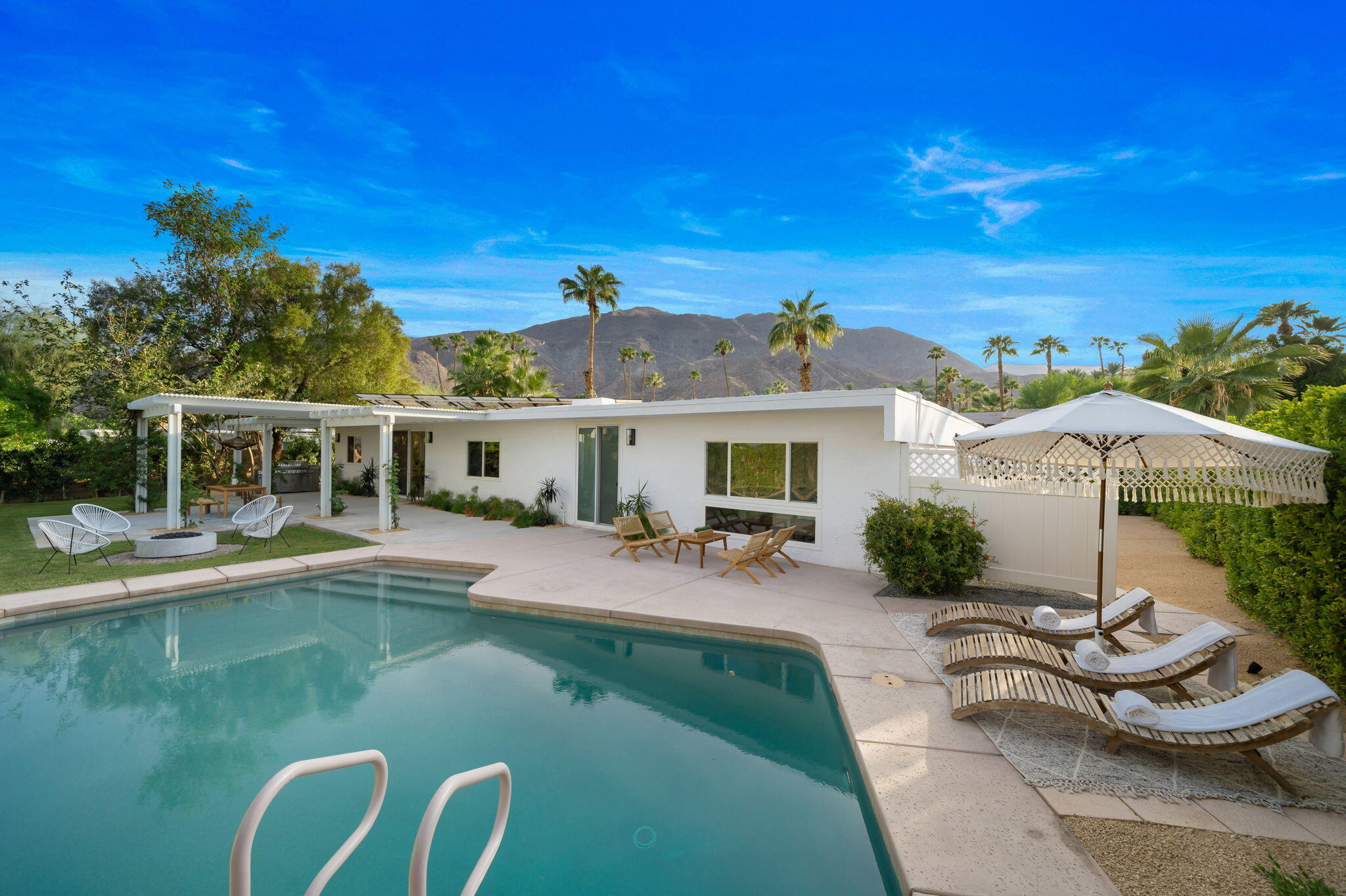 71540 Halgar Road Rancho Mirage, CA 92270 - Photo 50 of 51 a view of house with swimming pool yard fire pit and outdoor seating