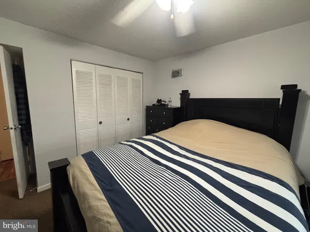 a bedroom with a bed and a mirror