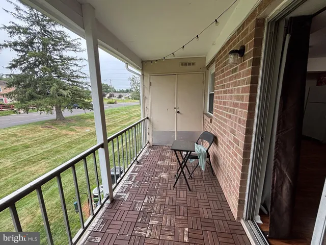 a view of a balcony with wooden floor