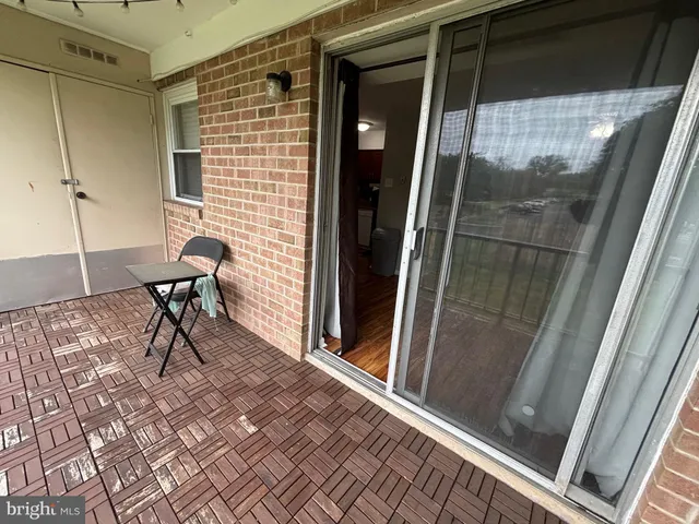 a view of a door and chair in the balcony