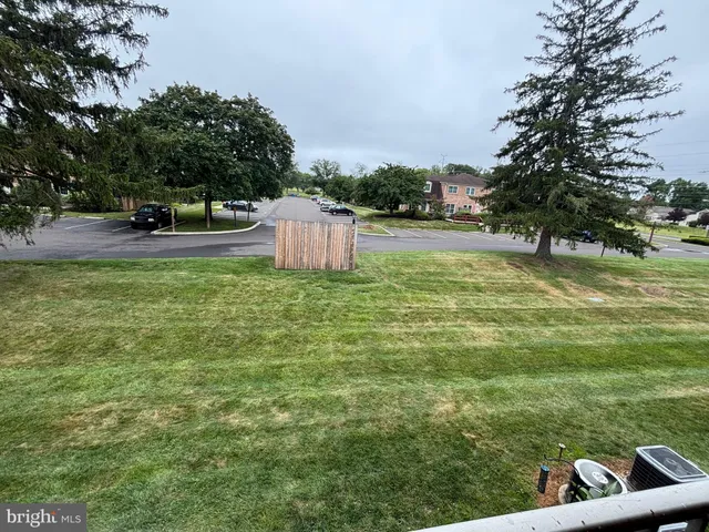 a view of a garden with lawn chairs